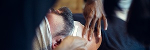 Barber shaving client's neck