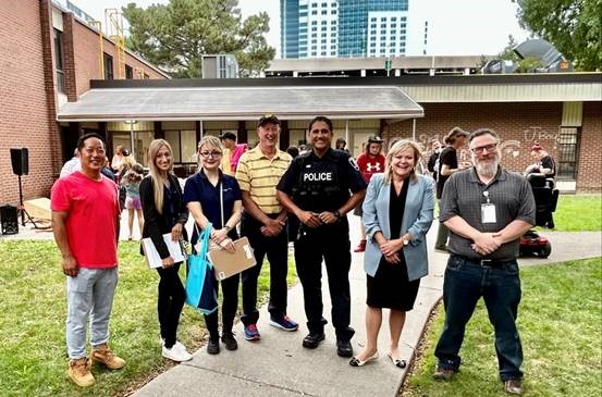 People from various agencies gathered outside at a Downtown Windsor Community Collaborative potluck event at Glengarry Complex