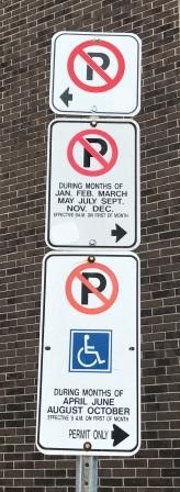 Three parking signs as detailed above