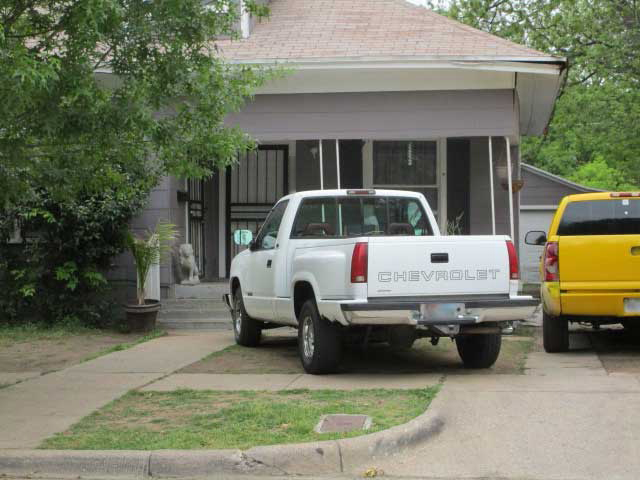 Pickup truck parked in a front yard