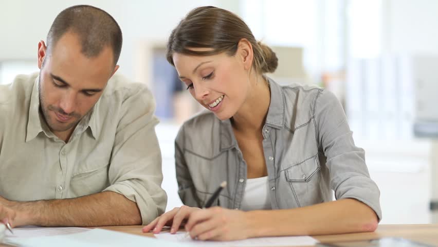 Man and woman filling out a form