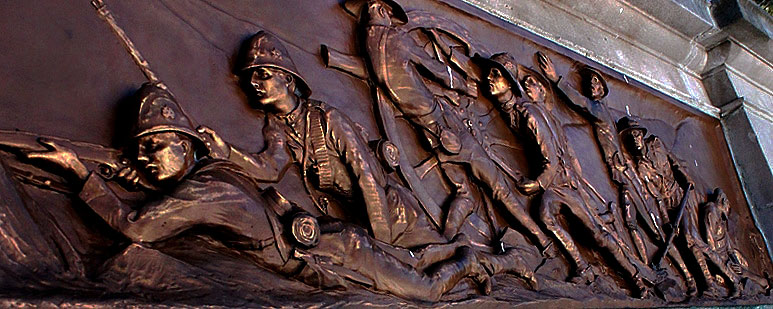 Detail of high relief bronze monument.