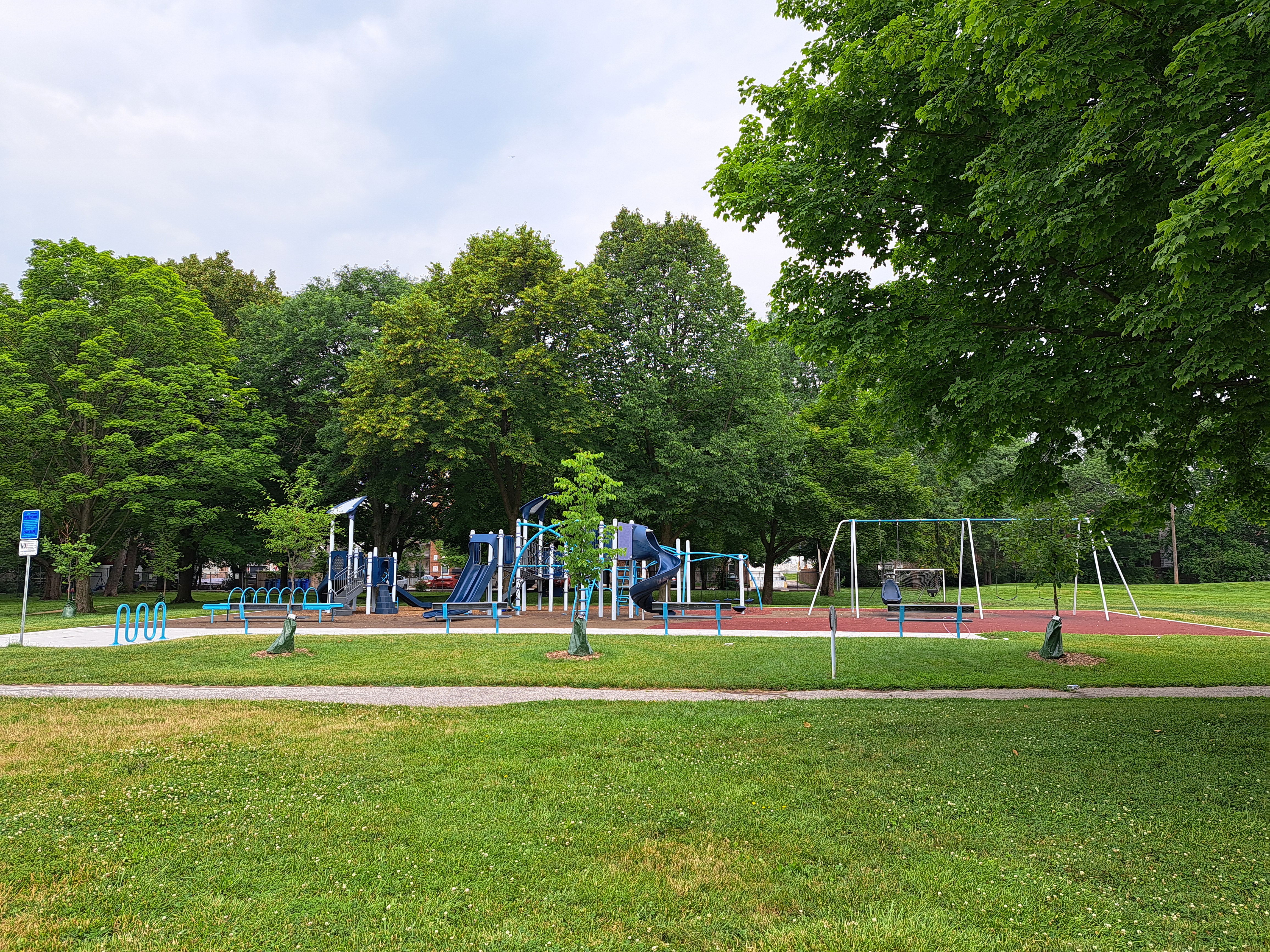 Playground surrounded by trees and pathway