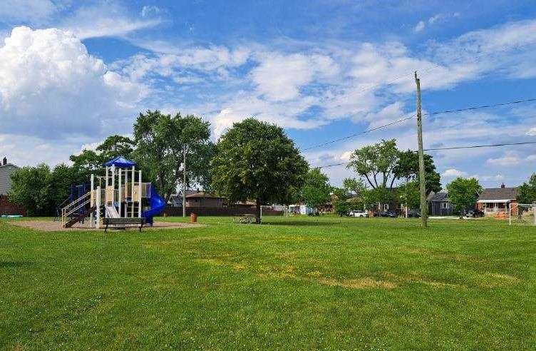 Playground surrounded by field of grass