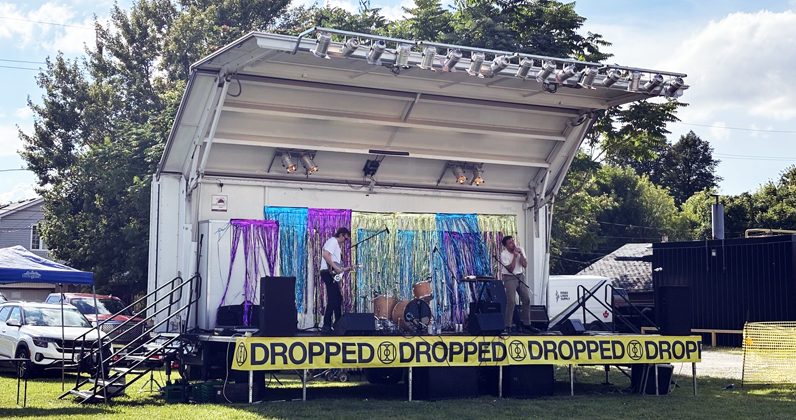 Musicians on the Showmobile stage at Dropped on Drouillard event