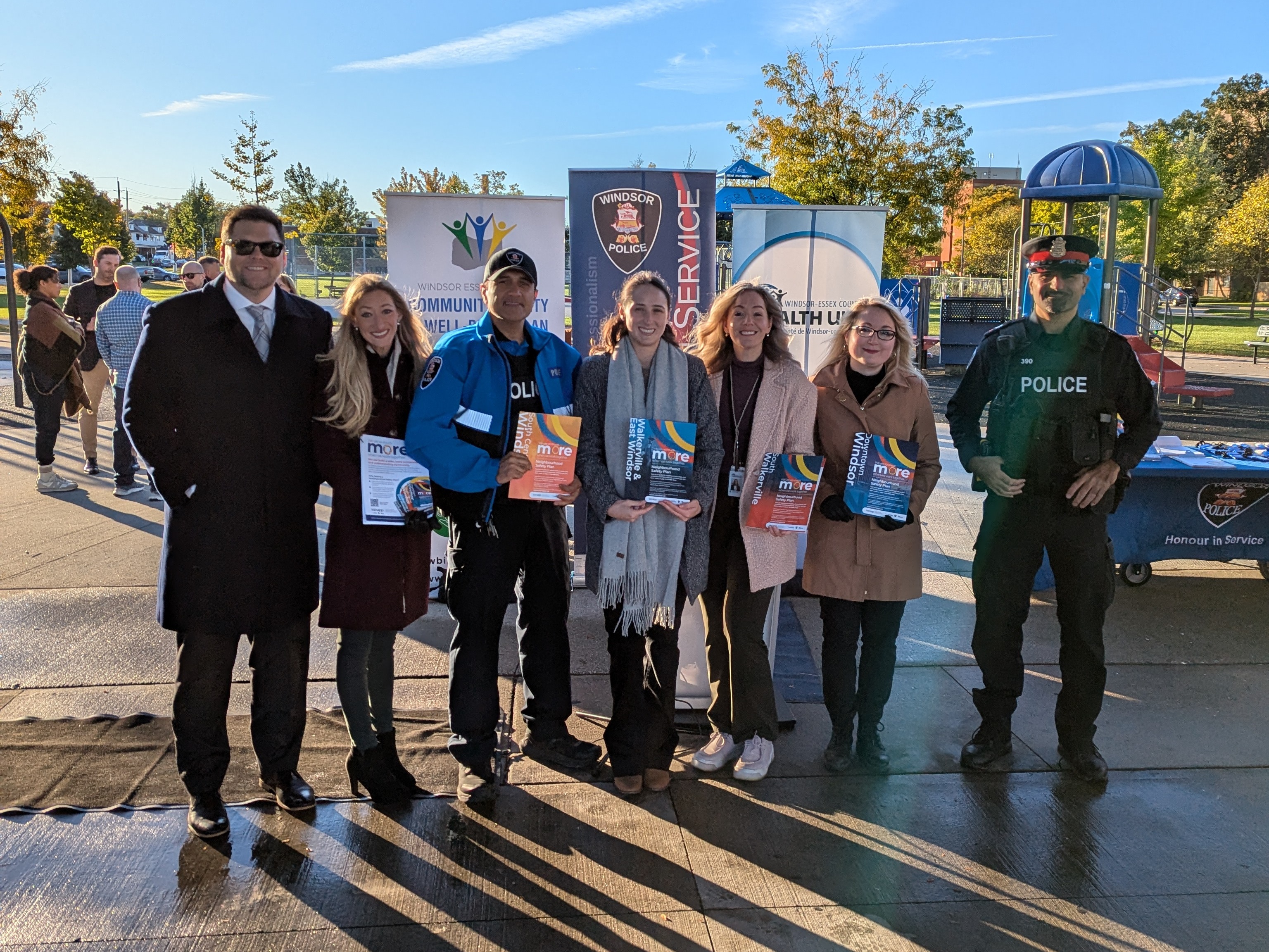 Representatives from the City of Windsor, Windsor Police Service, and Windsor-Essex County Health Unit holding SSNAPP Neighbourhood Safety Plans outside at a park